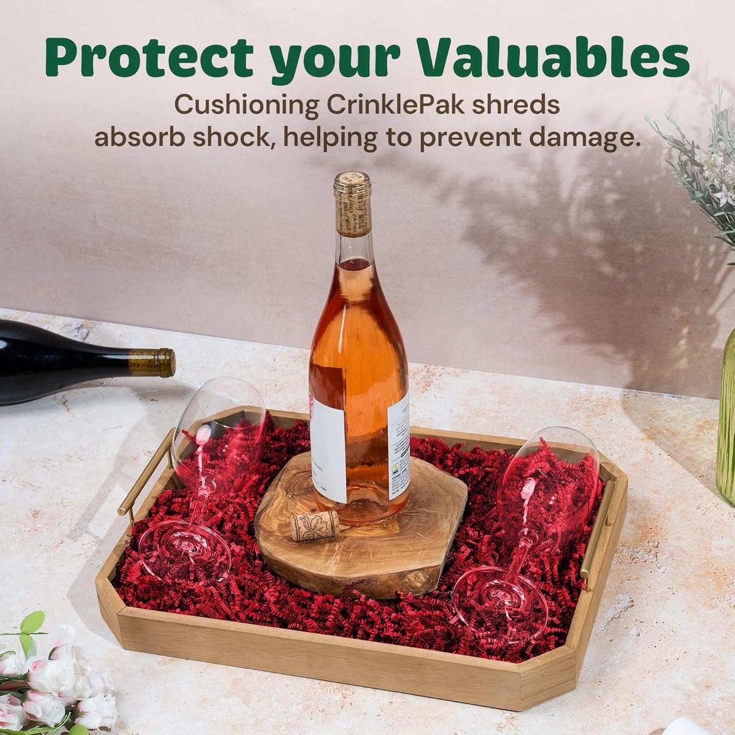 Red crinkle cut shred cushioning packaging with wine bottle and glasses in wooden tray