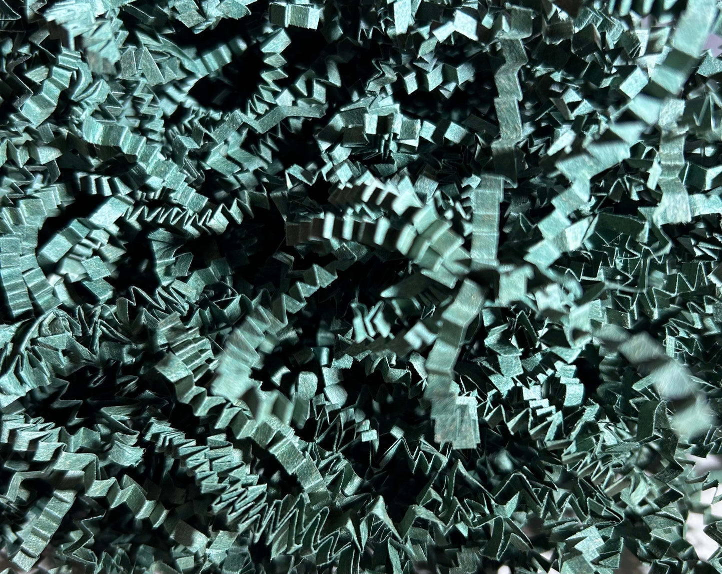 Dark green crinkle cut shred for luxurious gift packaging and cushioning.