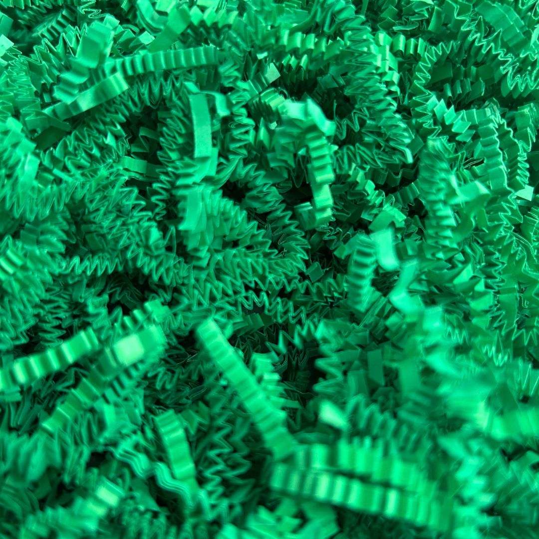 Green crinkle cut paper shred for packaging and gift presentation.